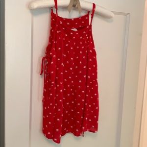 Red and white flowing tank with side ties.